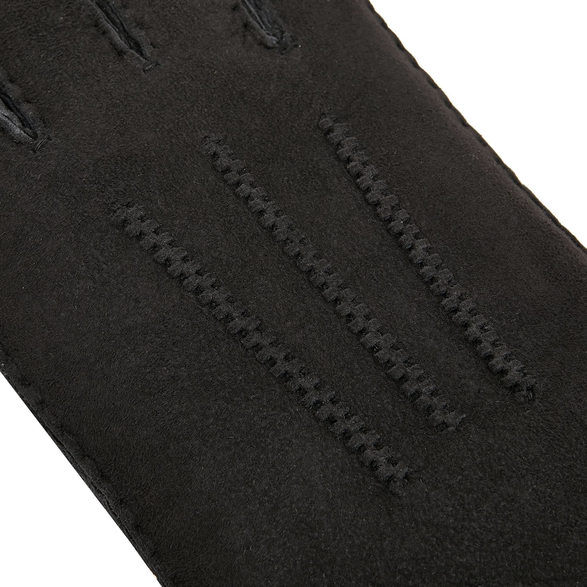 Black sheepskin glove showing soft wool texture and stitched seams in close-up detail. - Yellow Earth Australia