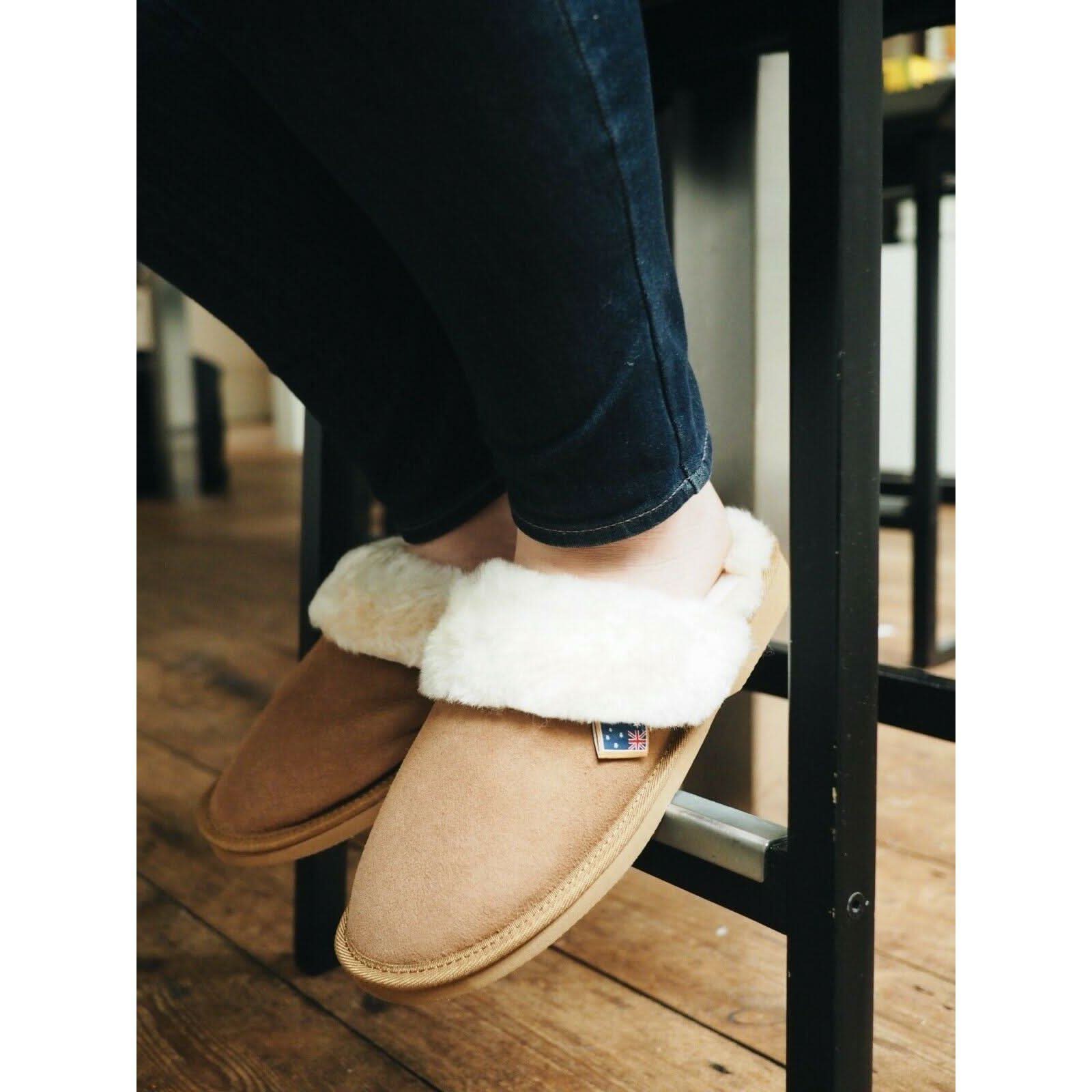 Tan sheepskin mule slipper with cream wool lining, shown on foot from side angle. - Yellow Earth Australia