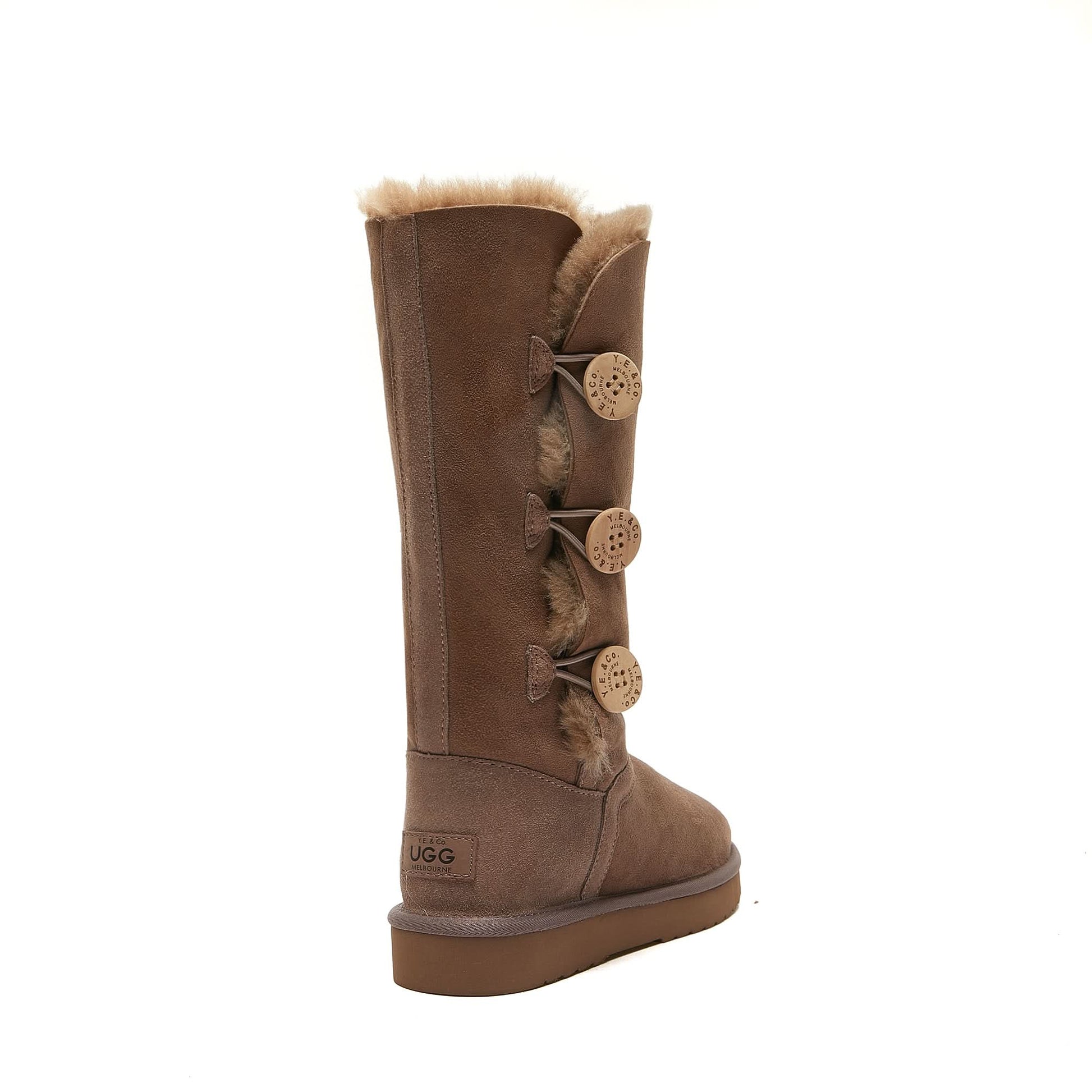 Brown tall sheepskin UGG boot with four side buttons and plush fur lining on white background