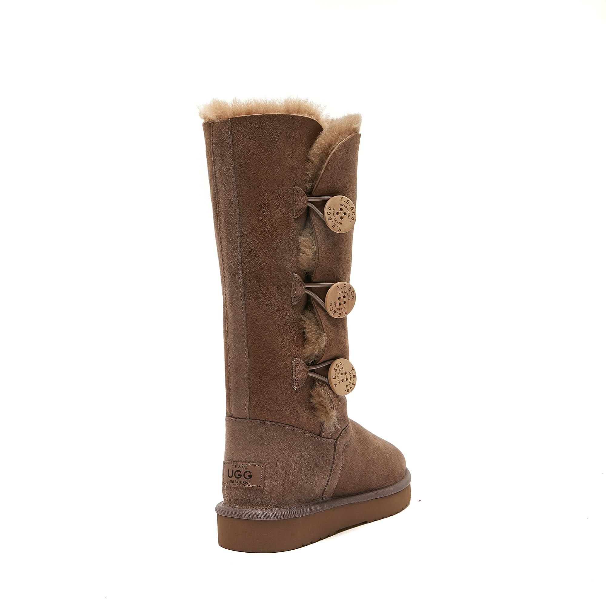 Brown tall sheepskin UGG boot with four side buttons and plush fur lining on white background