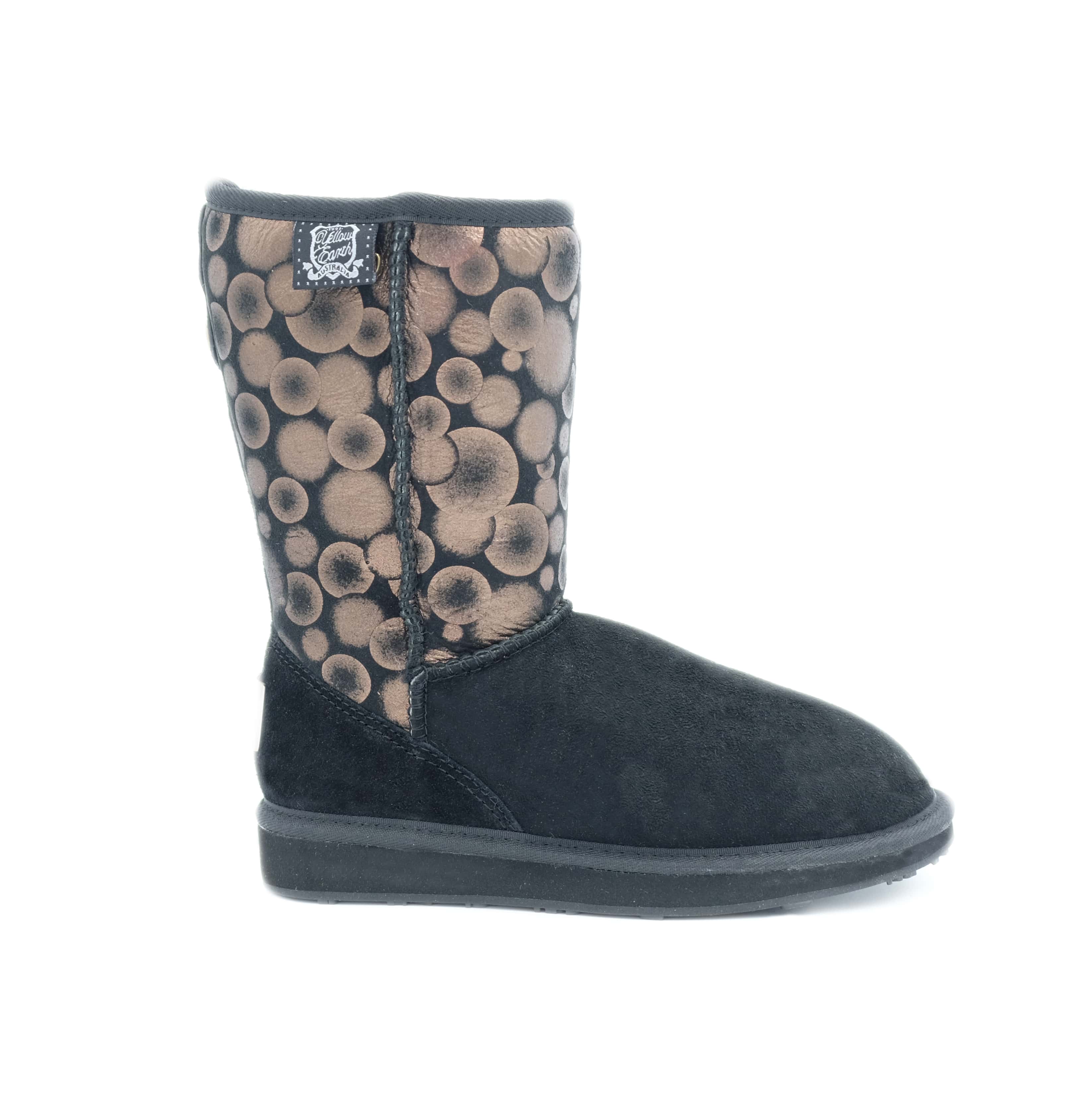 Black and tan sheepskin boot with circular pattern upper, side view. - Yellow Earth Australia