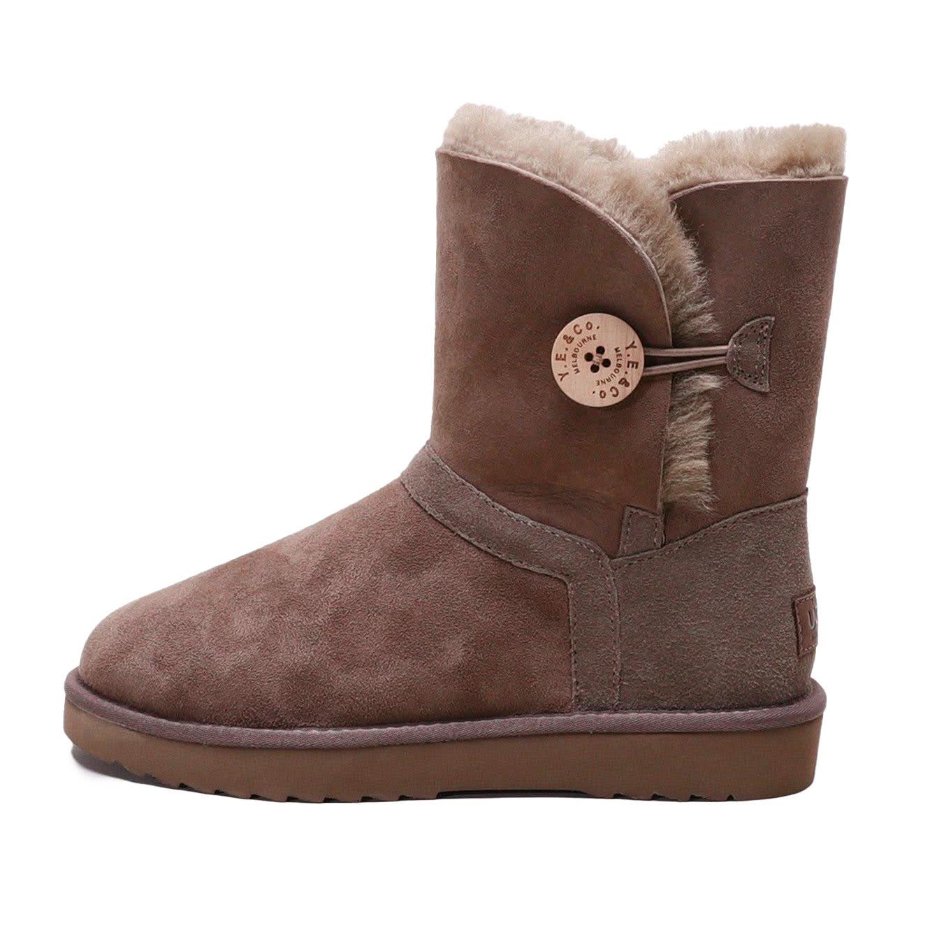 Brown sheepskin boot with fluffy wool lining and decorative button, side view. - Yellow Earth Australia