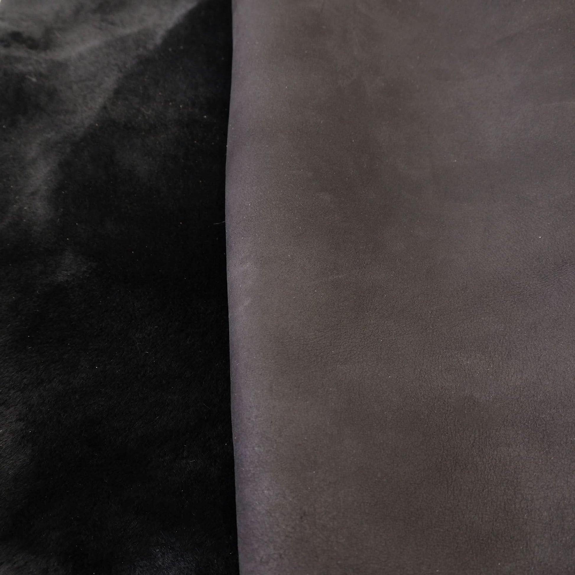 Black and charcoal sheepskin rugs displayed side by side showing soft wool texture. - Yellow Earth Australia