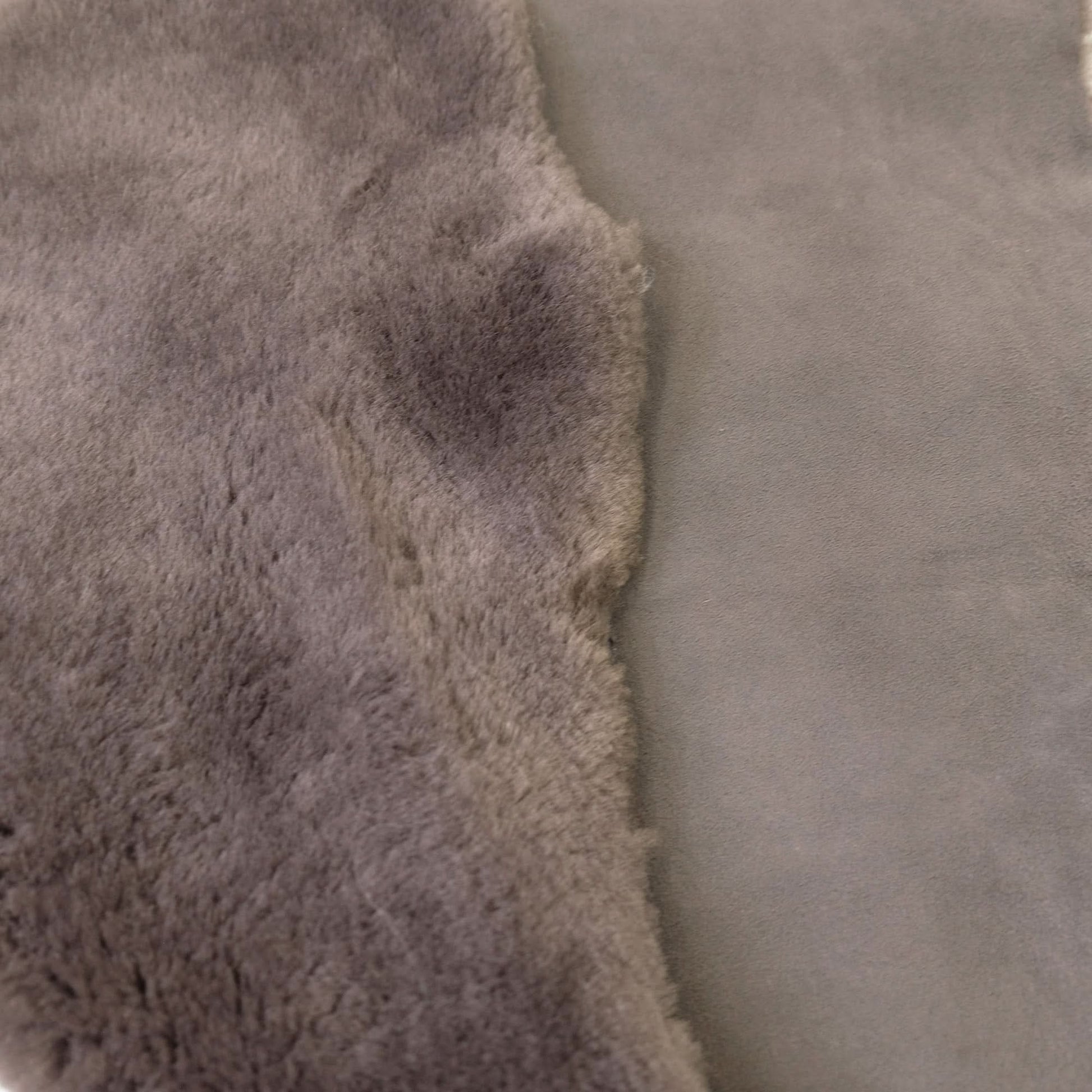 Close-up of natural sheepskin rug showing soft wool pile texture in cream and grey tones. - Yellow Earth Australia