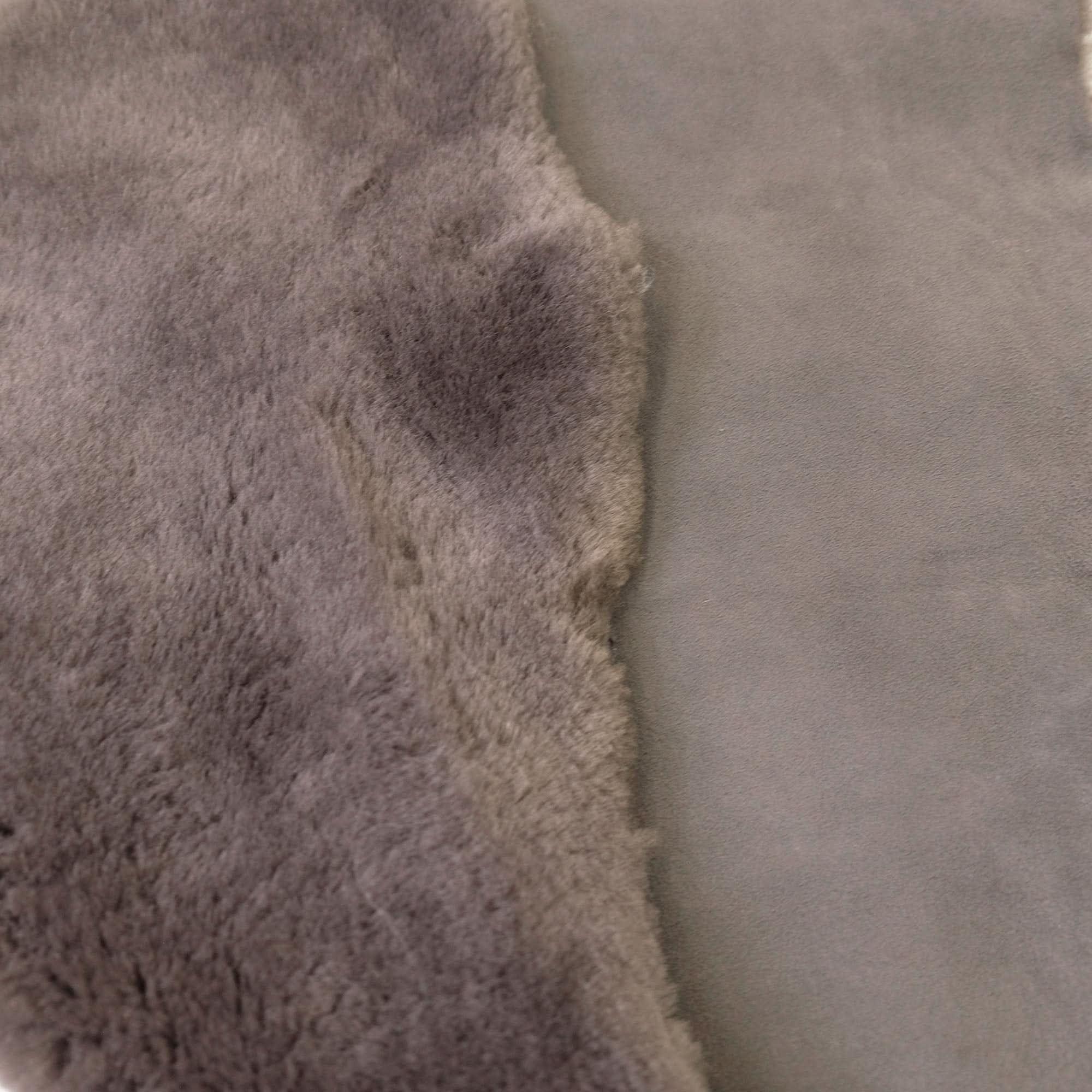 Close-up of natural sheepskin rug showing soft wool pile texture in cream and grey tones. - Yellow Earth Australia