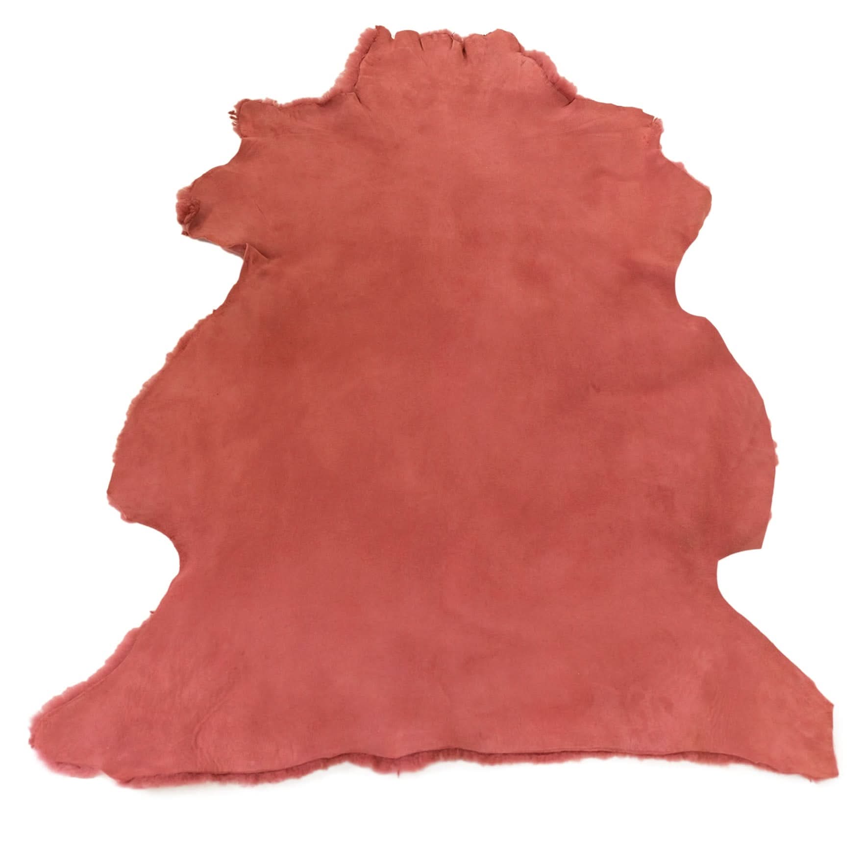 Red sheepskin rug with natural wool texture displayed flat against white background. - Yellow Earth Australia