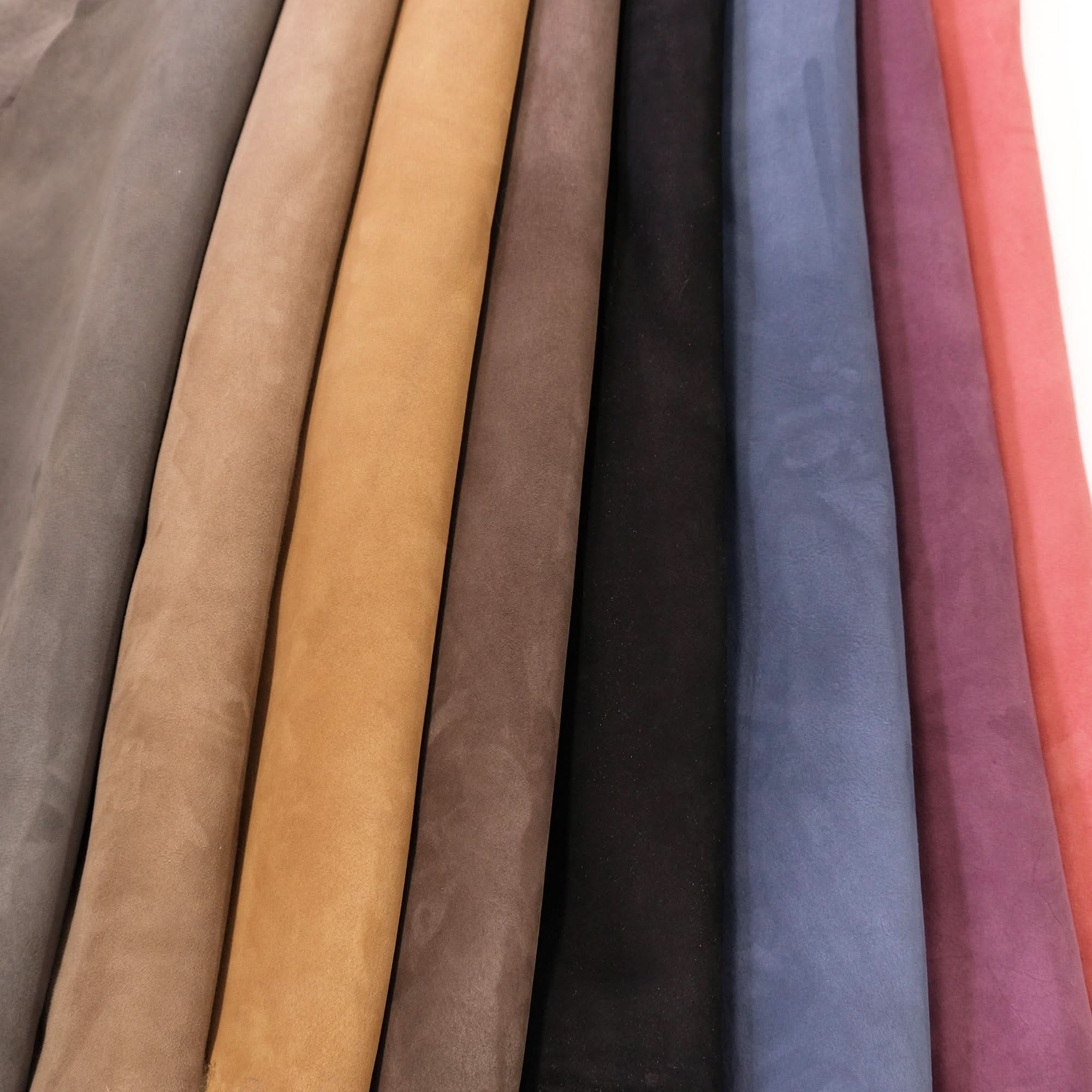 Wool fabric color swatch collection displaying taupe, beige, tan, brown, black, blue and pink tones. - Yellow Earth Australia