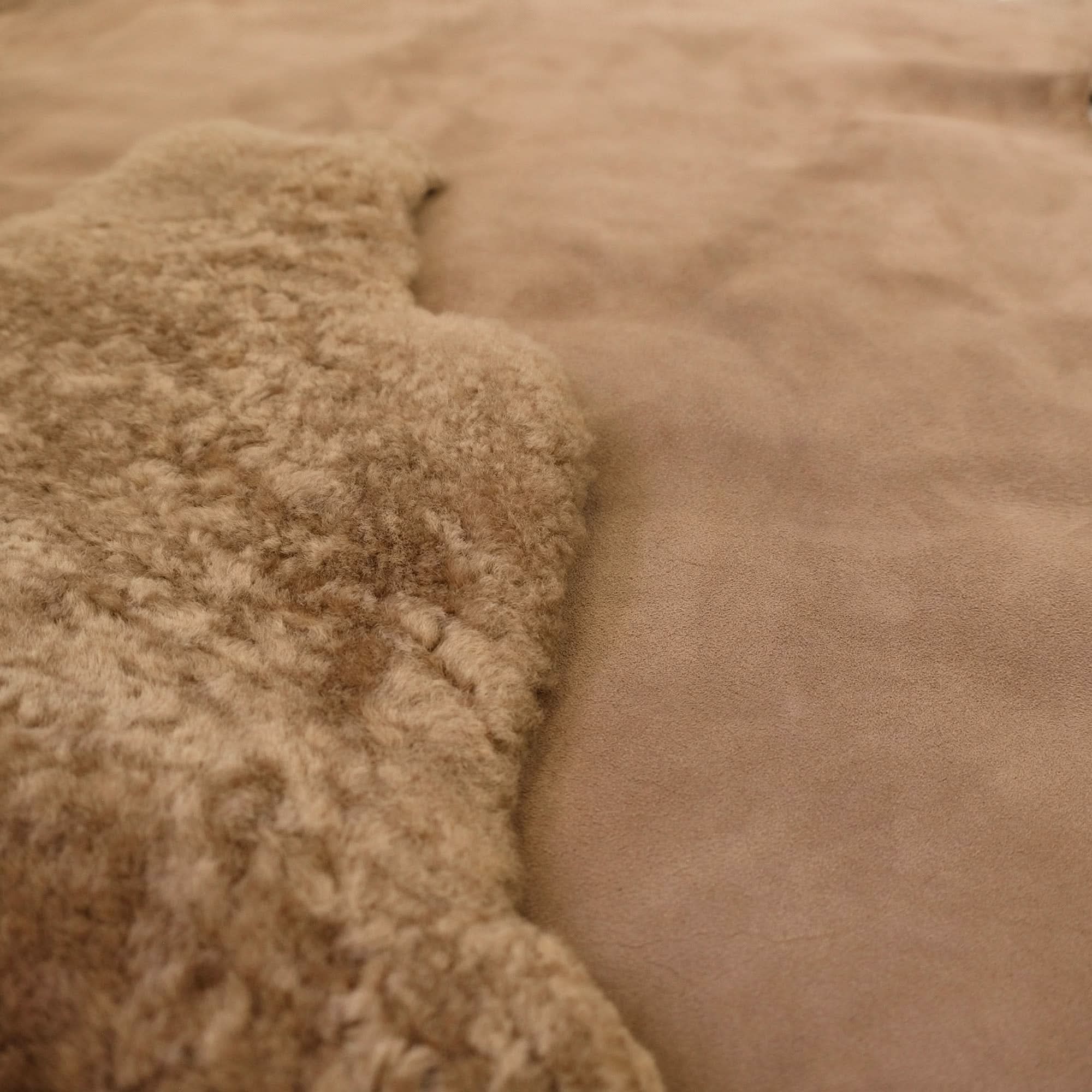 Natural sheepskin rug with soft wool texture in close-up detail view. - Yellow Earth Australia