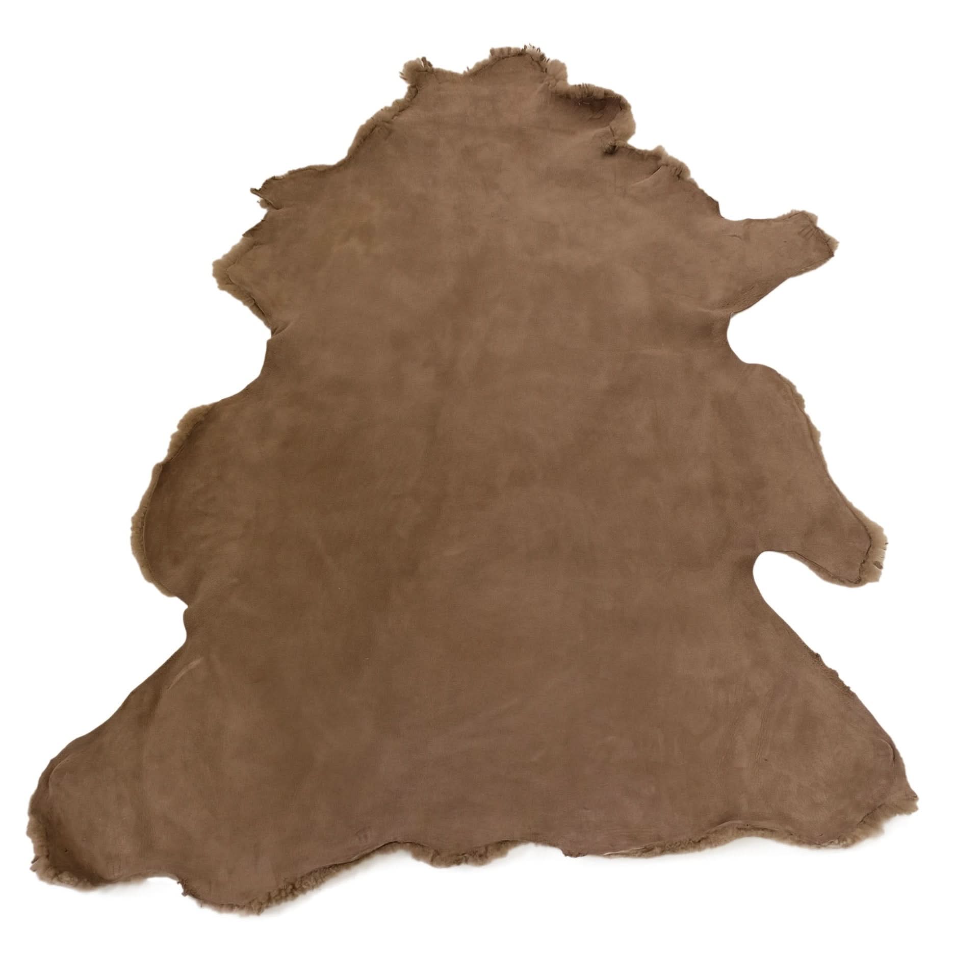Brown sheepskin rug with natural wool texture, top-down flat lay view. - Yellow Earth Australia