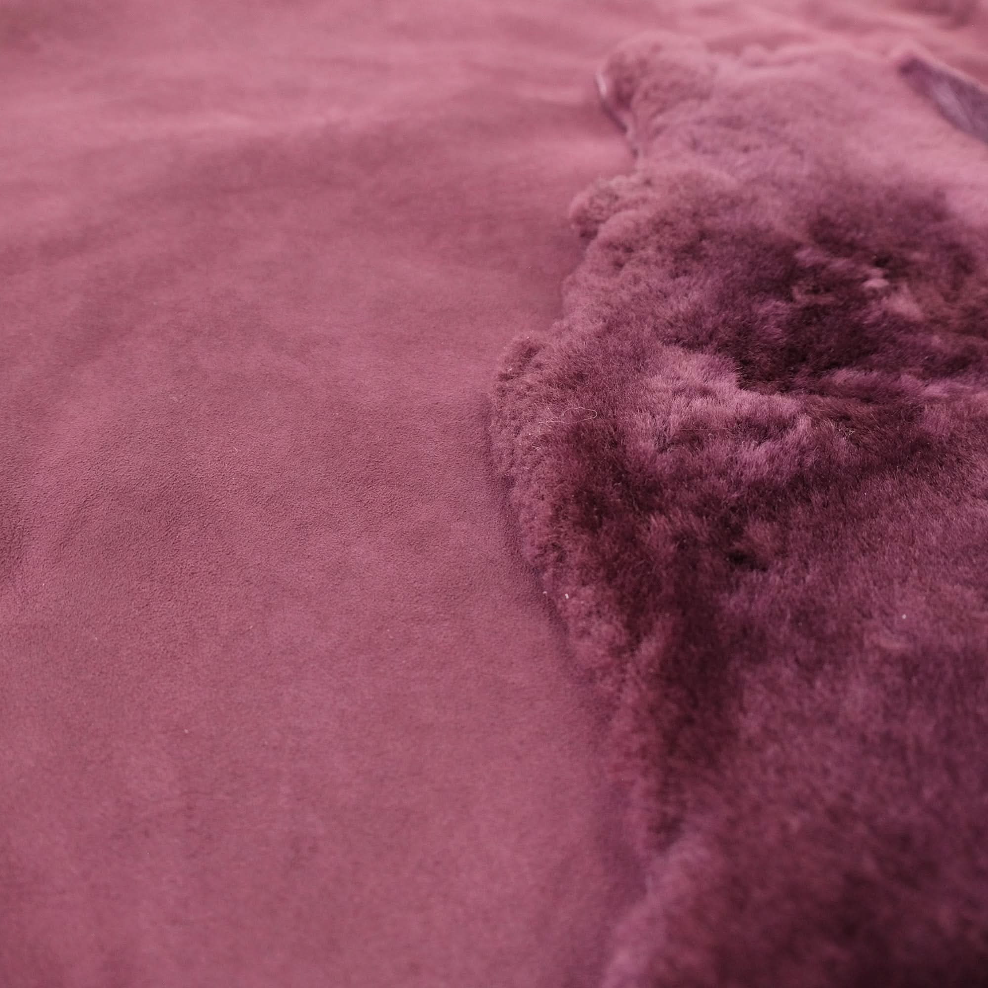 Mauve sheepskin throw showing soft wool pile texture and folded edge detail. - Yellow Earth Australia