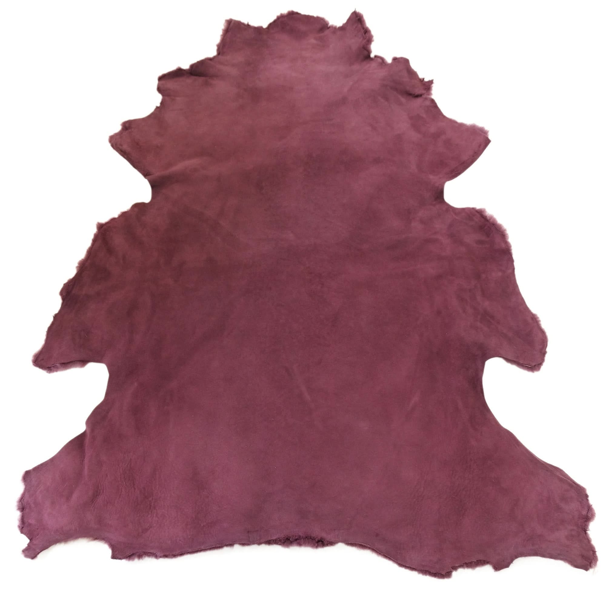 Burgundy sheepskin rug with natural wool texture displayed flat on white background. - Yellow Earth Australia
