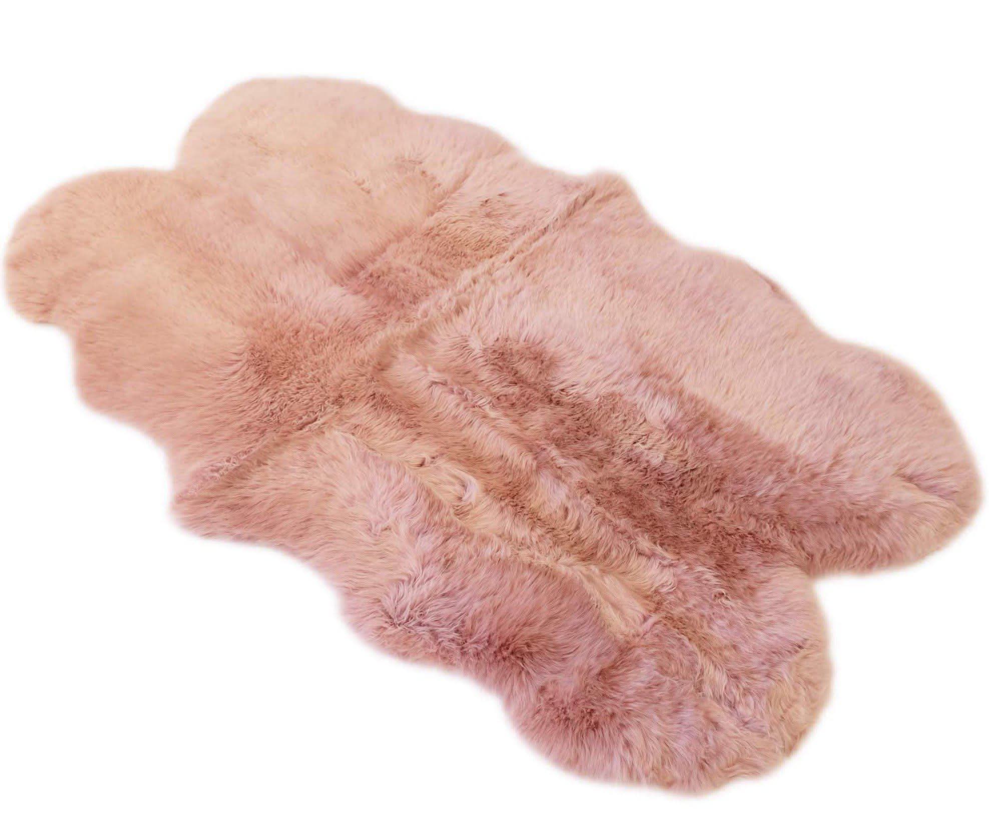 Soft pink sheepskin rug with natural wool texture, overhead view. - Yellow Earth Australia