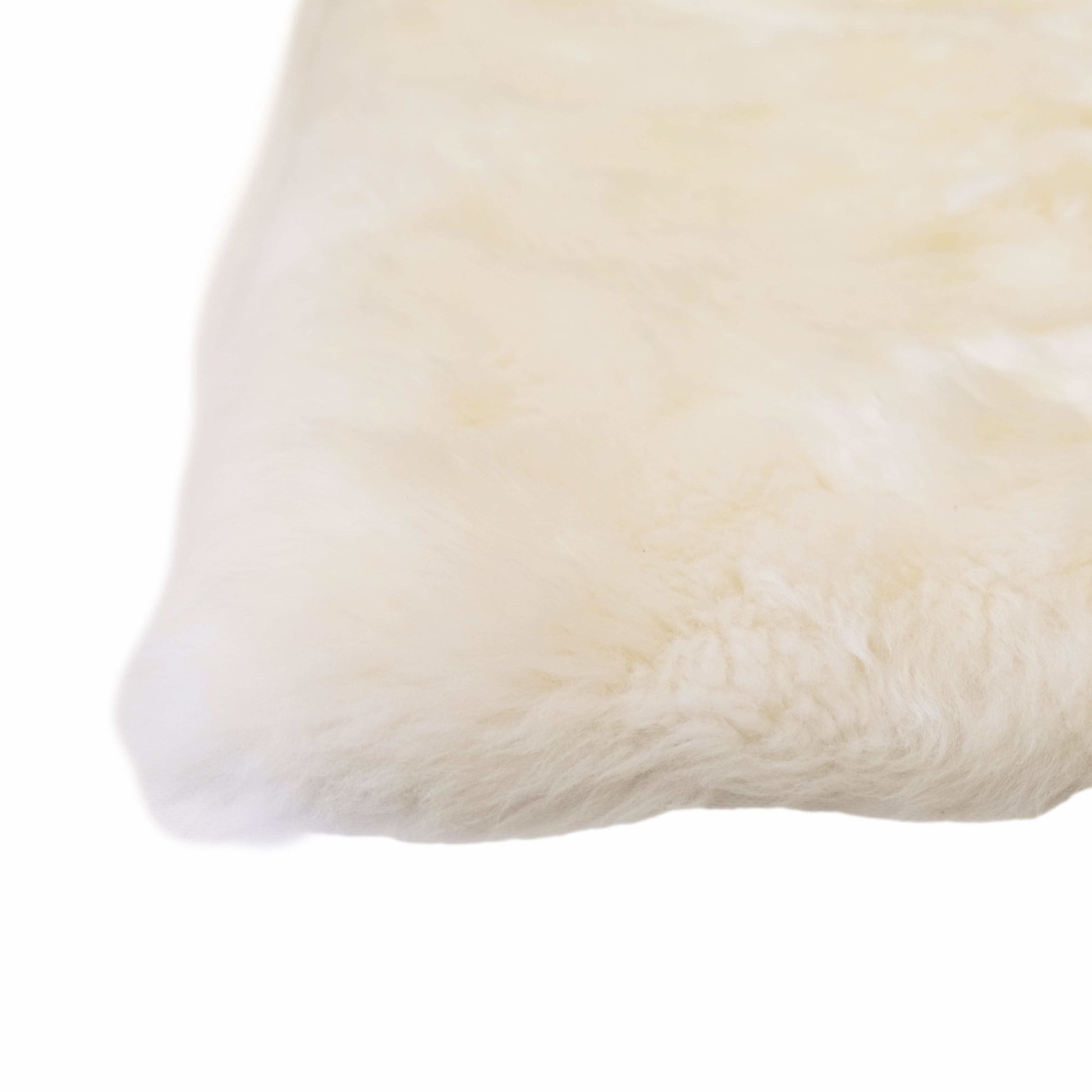 Cream sheepskin cushion cover with soft wool texture, corner detail view. - Yellow Earth Australia