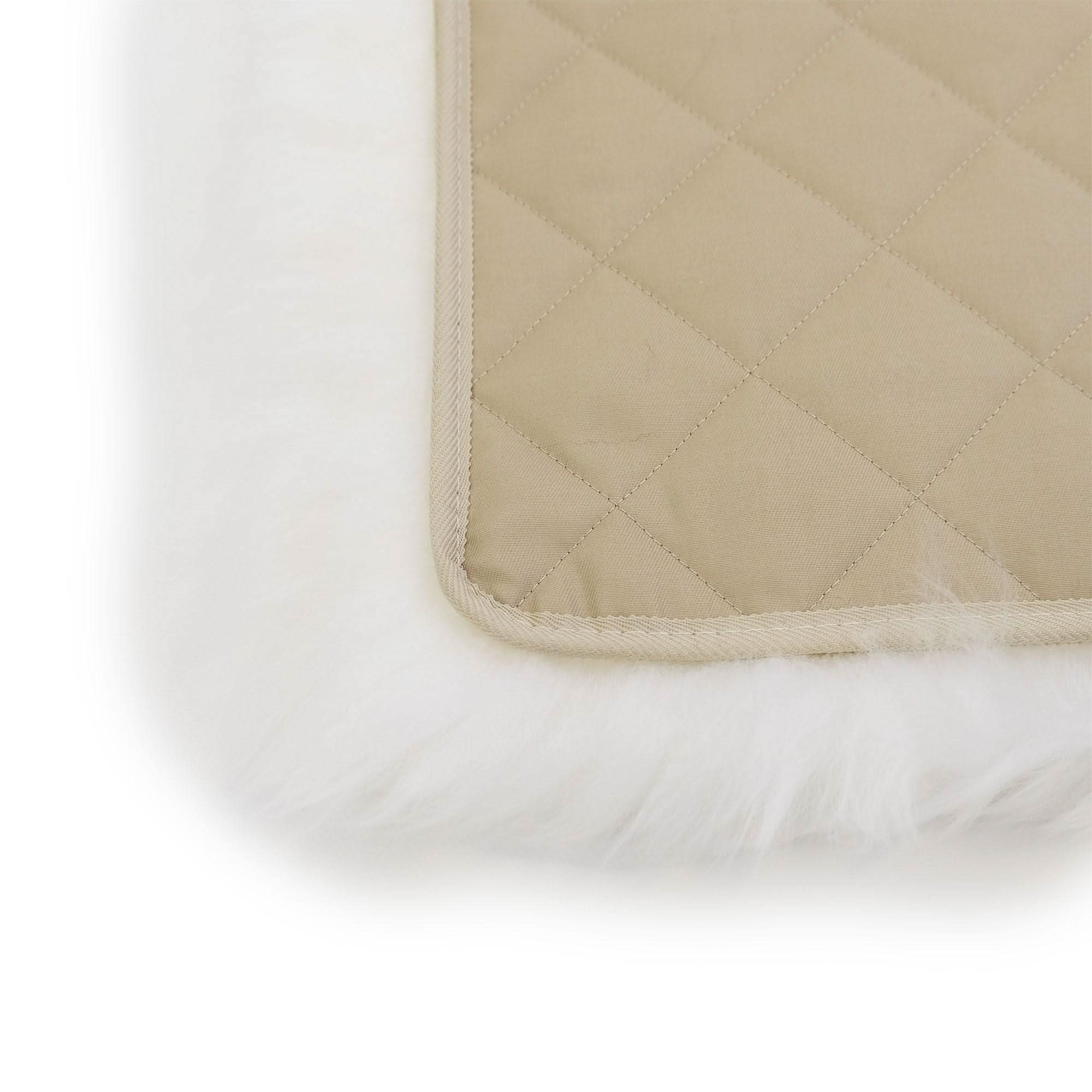 Quilted wool underlay with cream binding and white sheepskin base, corner detail view. - Yellow Earth Australia