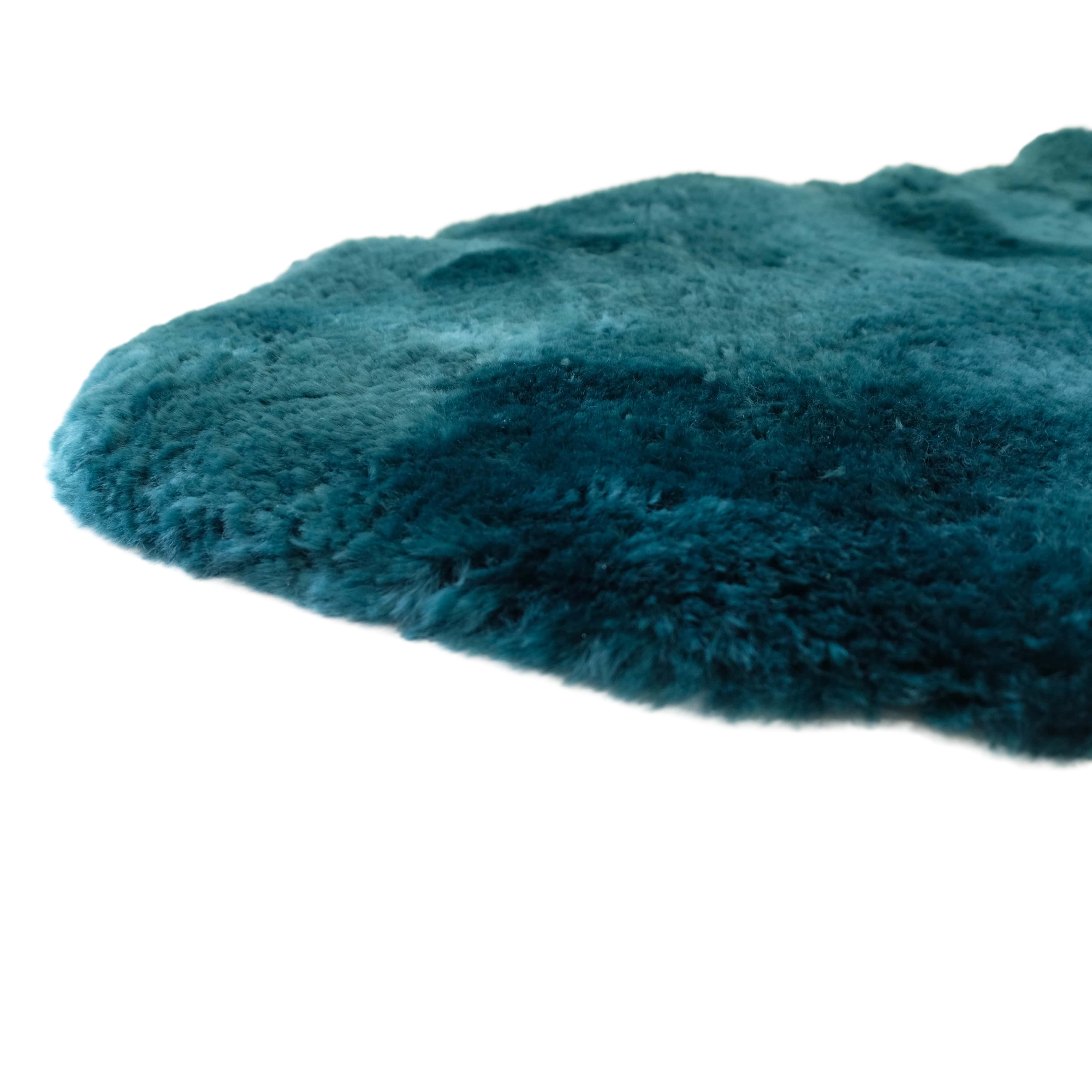 Teal sheepskin rug with soft wool pile shown from angled side view. - Yellow Earth Australia
