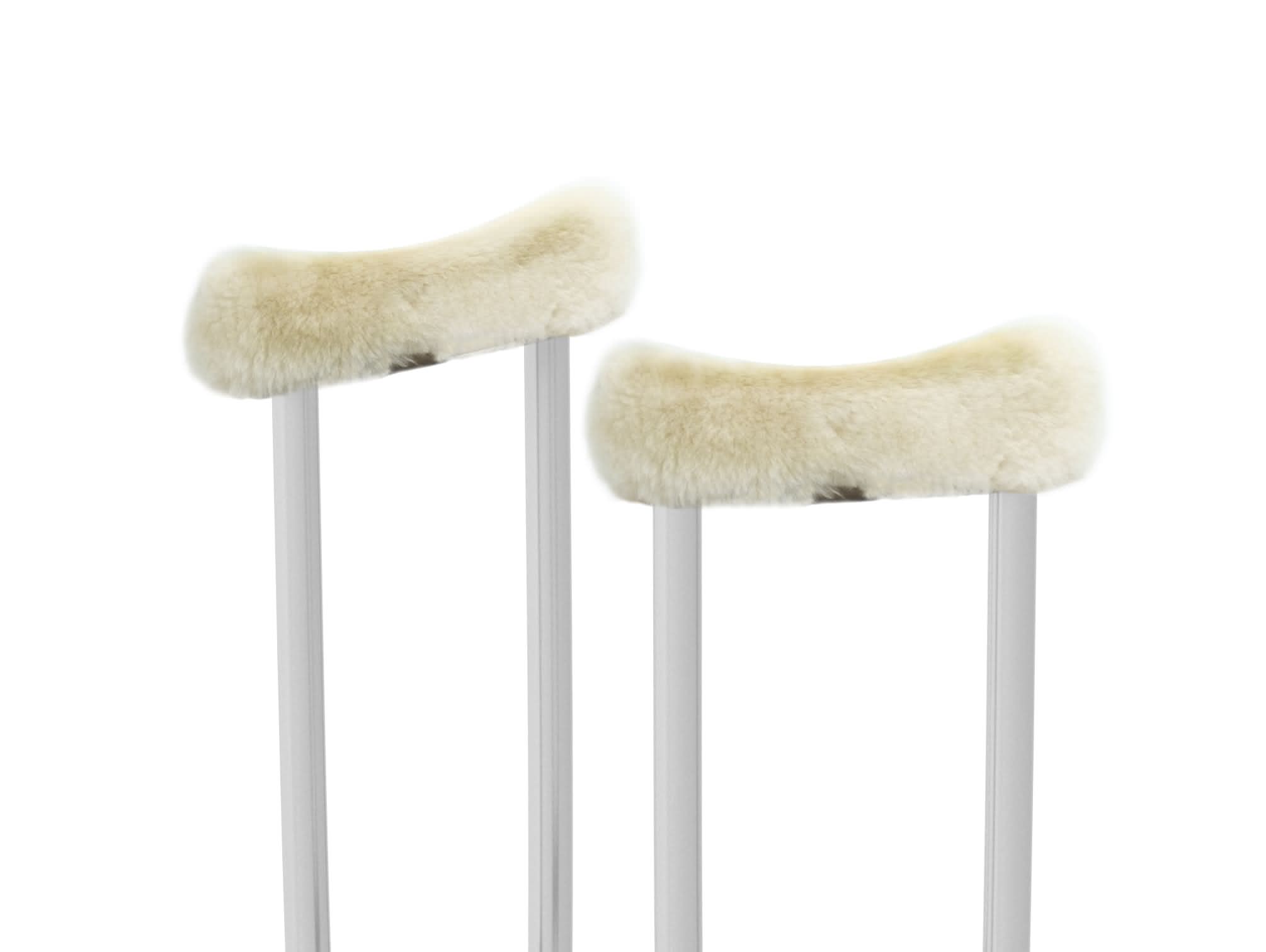 Pair of cream sheepskin chair rail covers on white poles, top view. - Yellow Earth Australia