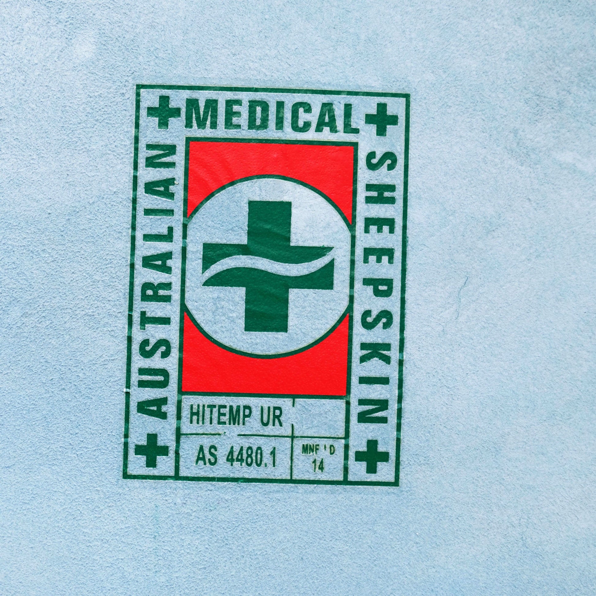 Australian first aid kit sticker with green cross on red and white background. - Yellow Earth Australia