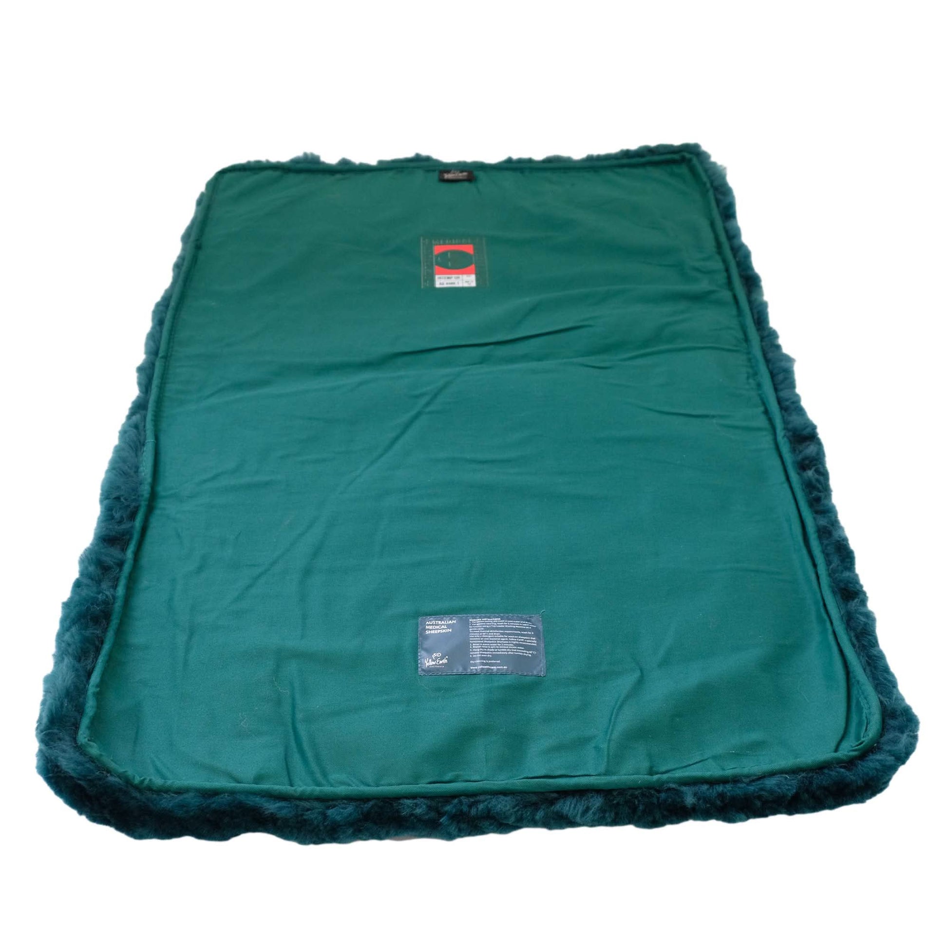 Teal sheepskin pet bed with fluffy wool border, top-down view. - Yellow Earth Australia