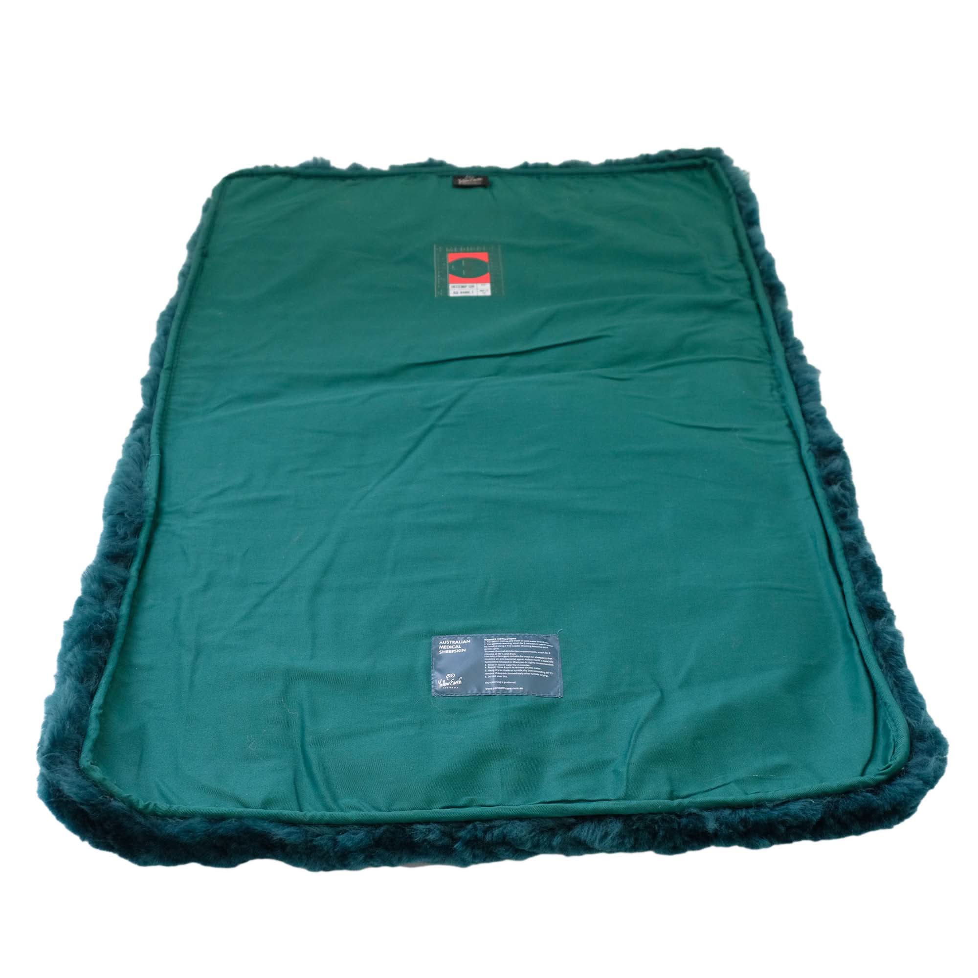 Teal sheepskin pet bed with fluffy wool border, top-down view. - Yellow Earth Australia