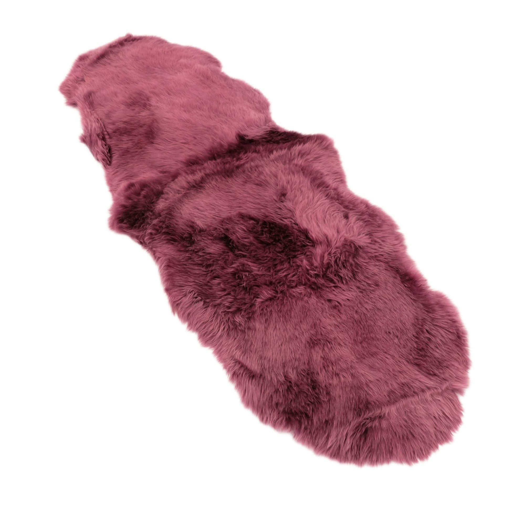 Pink sheepskin rug with soft curly wool texture, overhead view. - Yellow Earth Australia