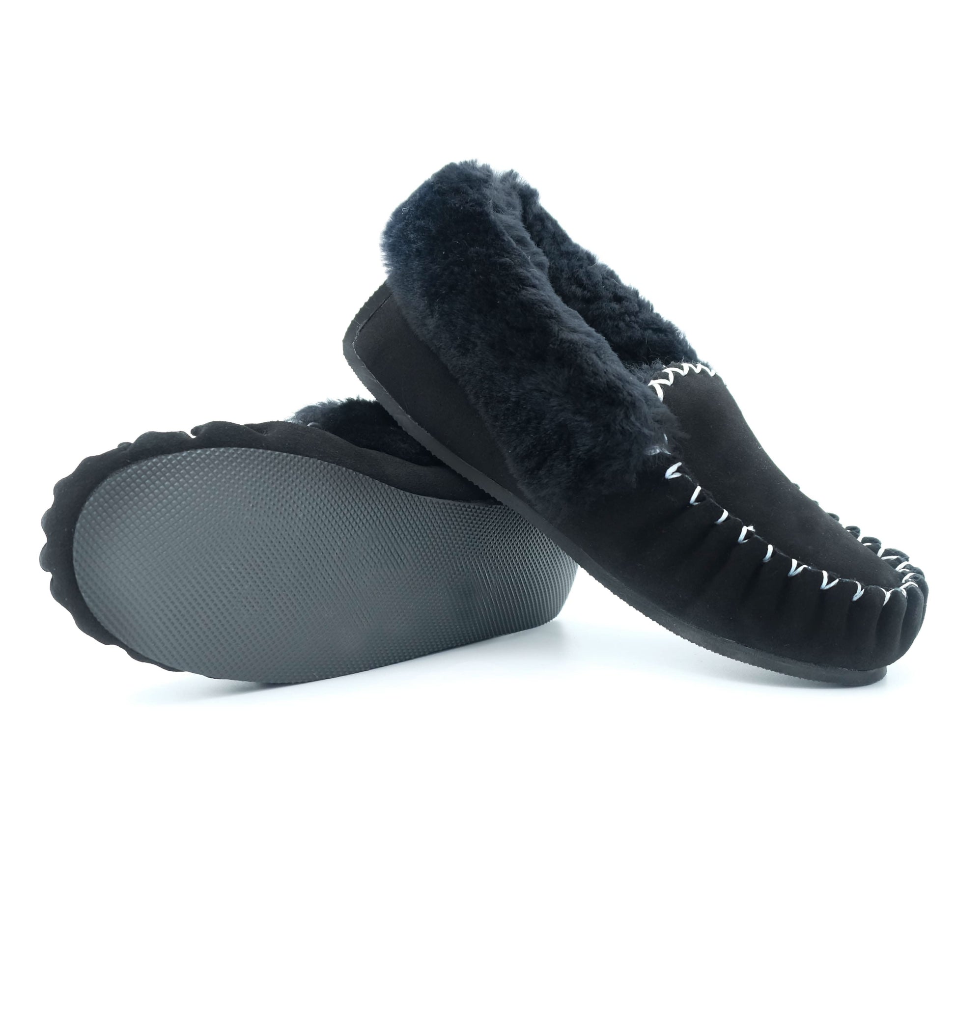 Black sheepskin moccasin slippers with fluffy wool lining, shown from sole and side view. - Yellow Earth Australia