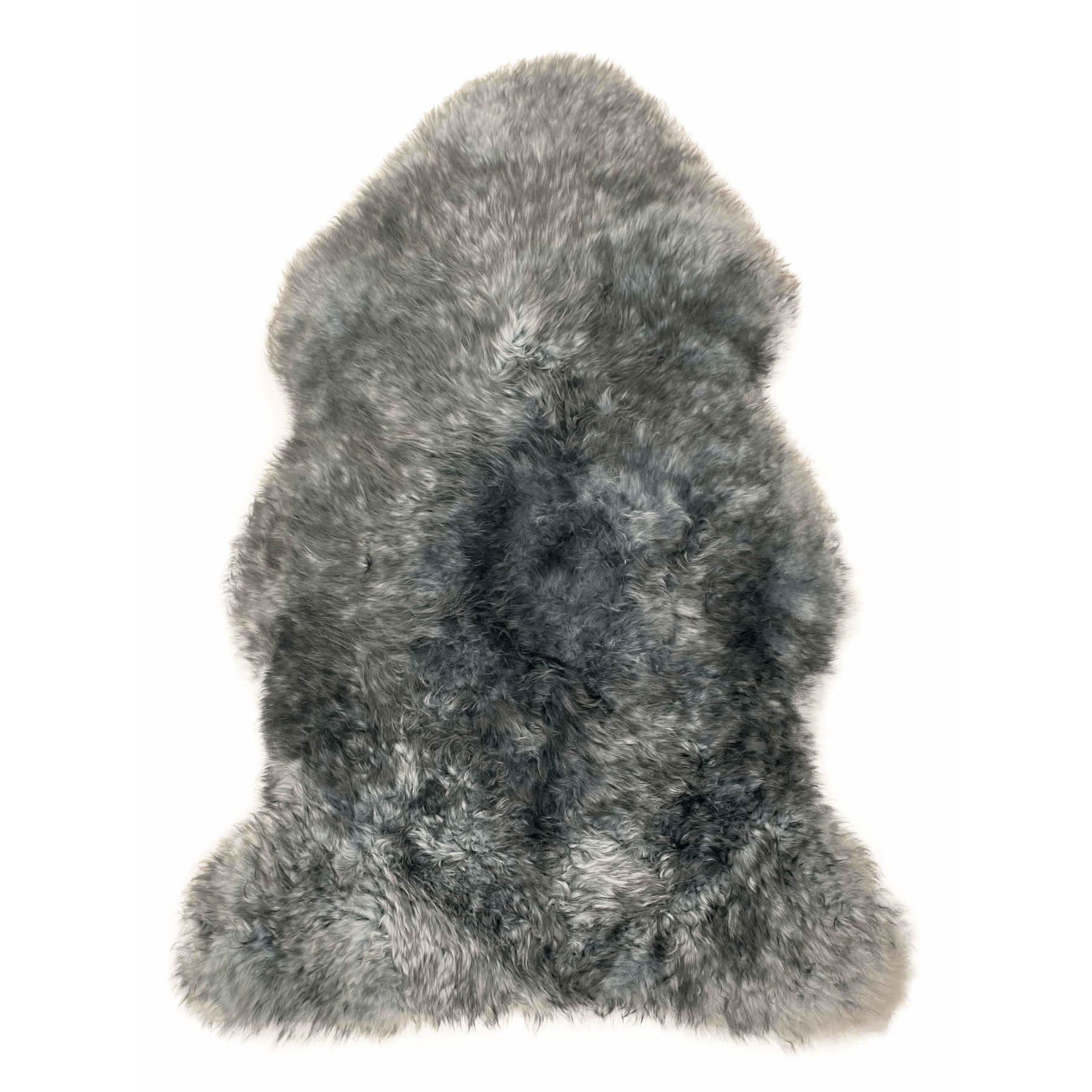 Grey sheepskin rug with natural wool texture viewed from above on white background. - Yellow Earth Australia