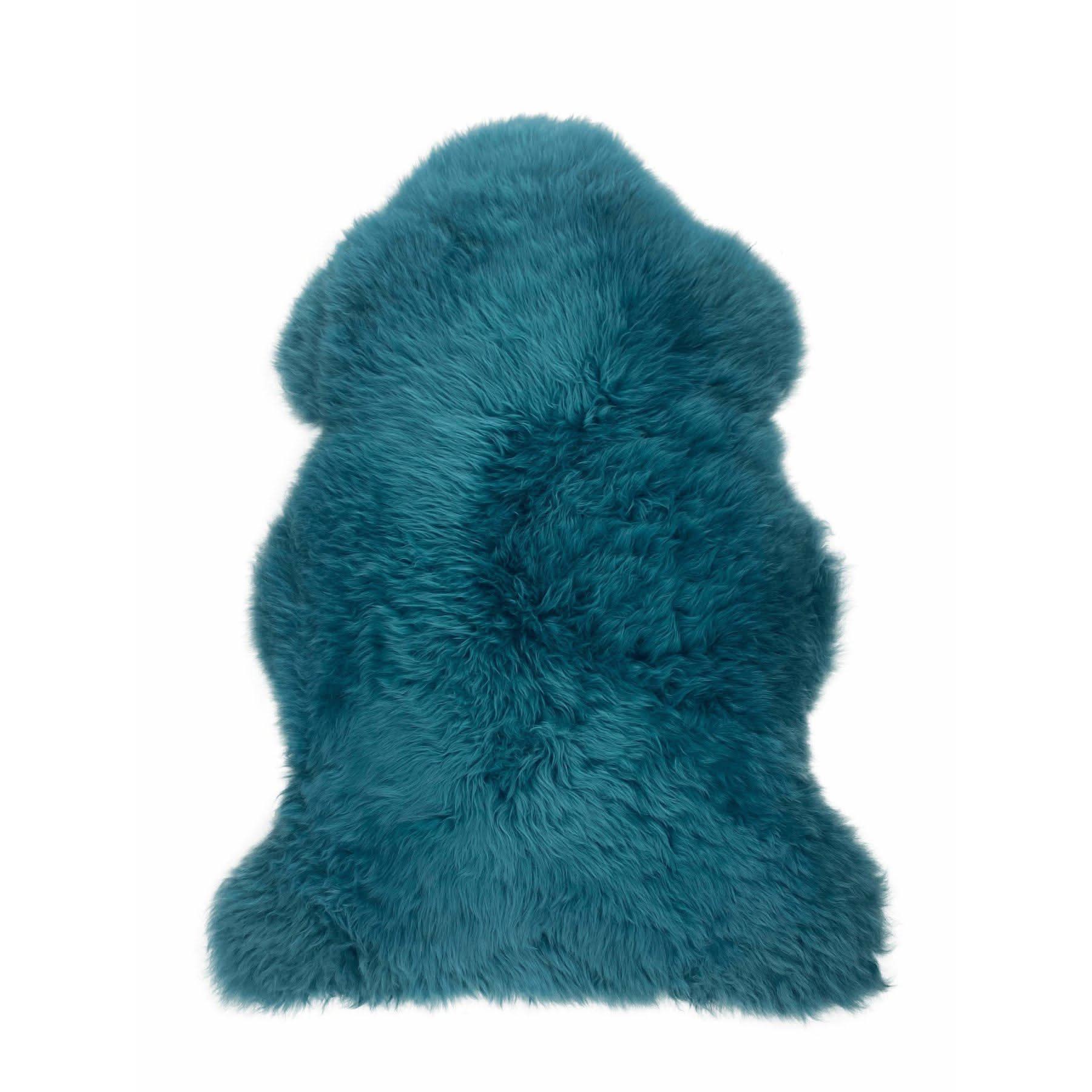 Teal sheepskin rug with thick wool pile viewed from above on white background. - Yellow Earth Australia