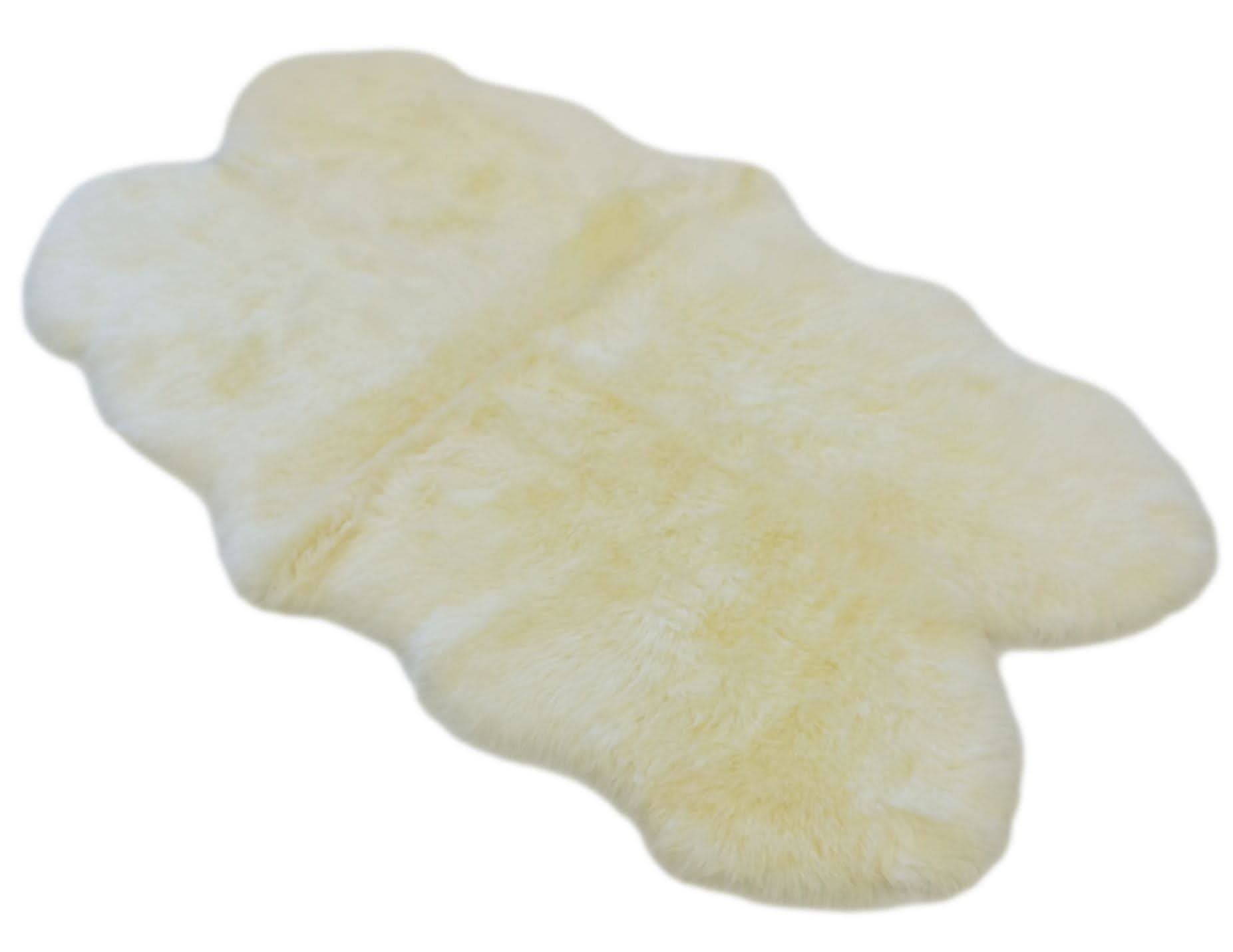 Cream sheepskin rug with soft wool texture viewed from above on white background. - Yellow Earth Australia