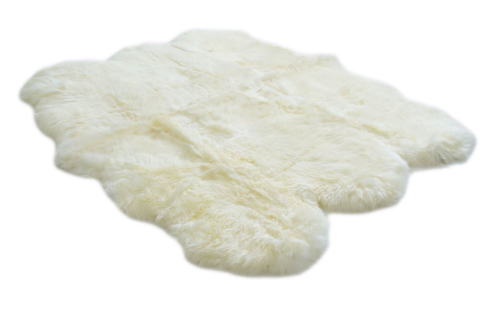 White sheepskin rug with soft wool fleece viewed from above on white background. - Yellow Earth Australia