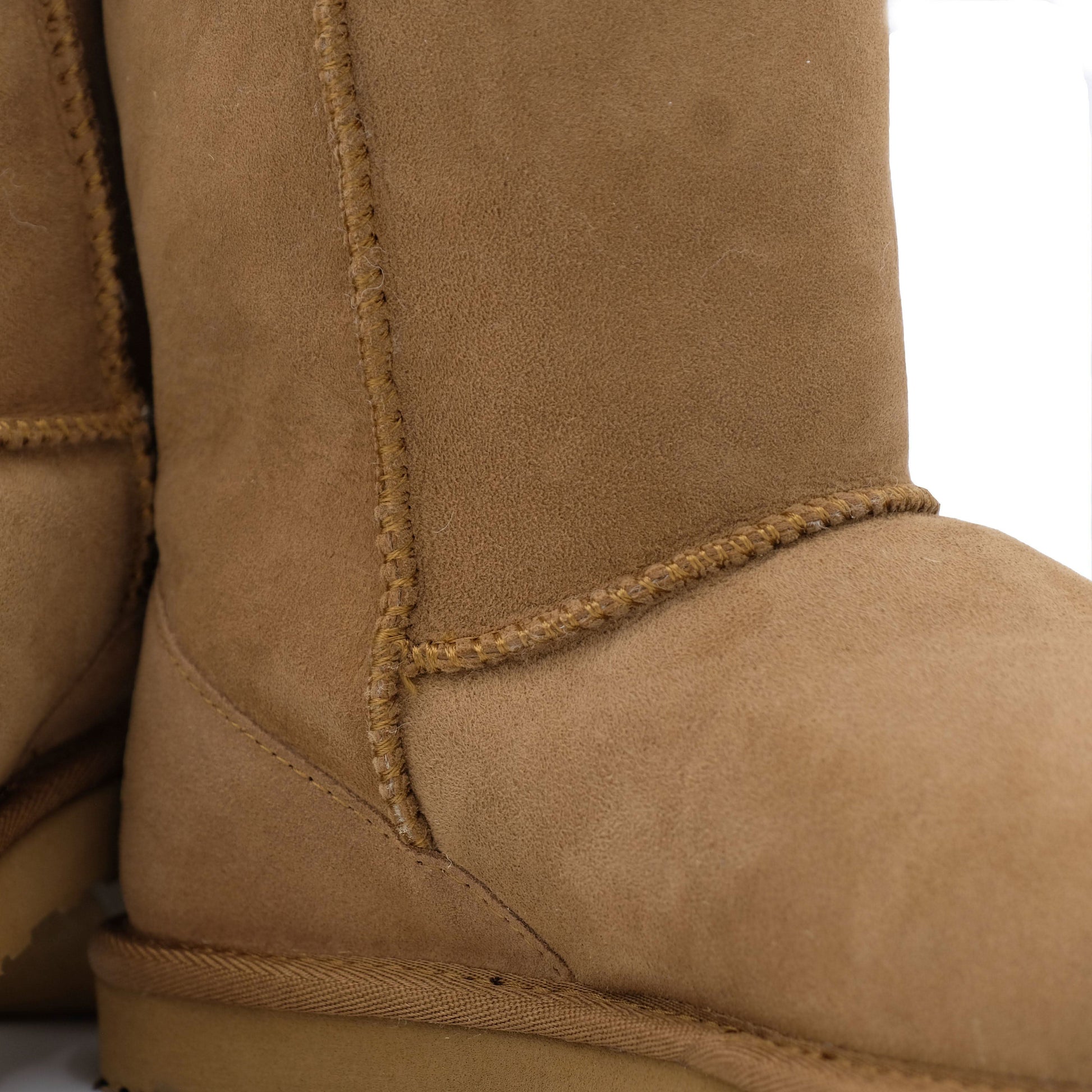 Tan suede sheepskin boot showing curved side seam and stitched detail. - Yellow Earth Australia